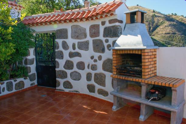 istock Fireplace on the backyard. Open summer barbeque kitchen with  grill. 1332519140