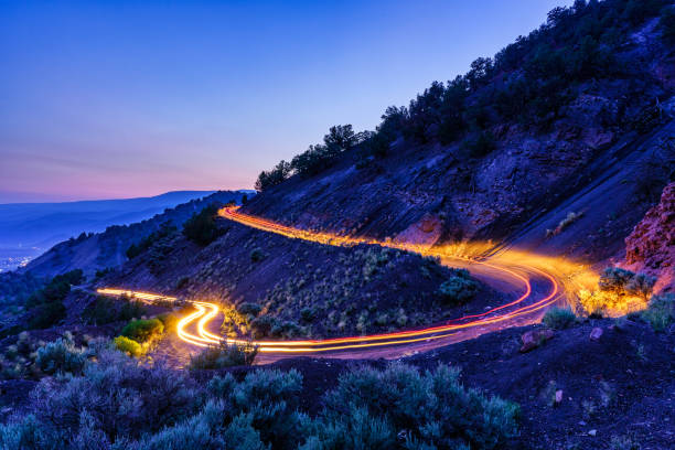 istock Long Exposure Light Trails Curvy Mountain Road 1332519183