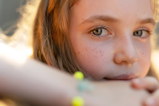 A closeup portraite of an eight years old freckled face girl