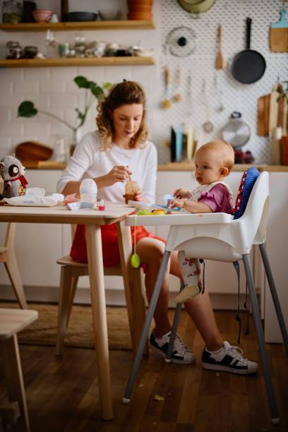 istock Mother feeding baby in the kitchen 1332520314