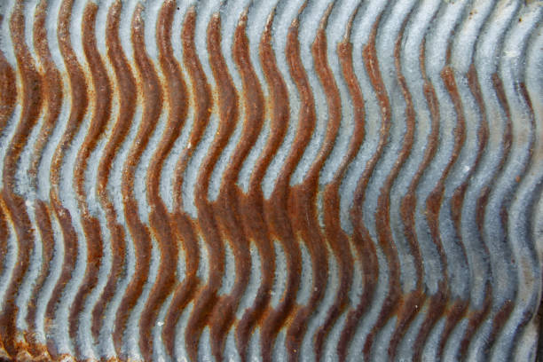 The texture of the old iron surface with corrugated edges covered with rust.