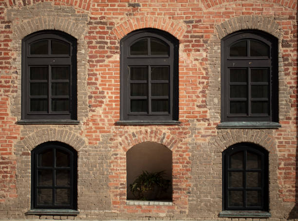 istock Brick wall of an old building with arched windows. 1332520758