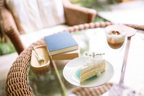 Coconut Cake and Coffee in a cafe on the blur background. traditional dessert Sliced of delicious coconut layer cake