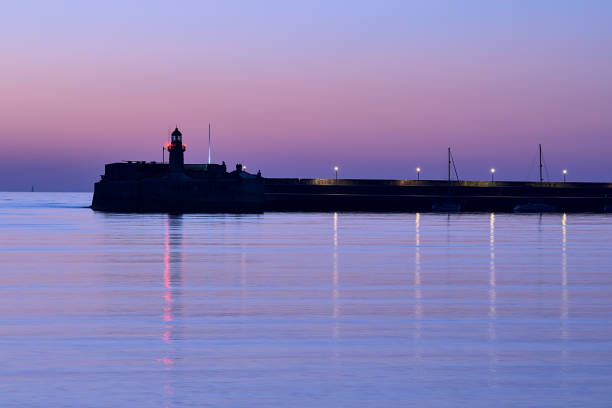 маяк восточного пирса знаменитой гавани дун лаогейр в течение синего часа перед восходом солнца, дублин, ирландия. морская тематика - dublin ireland стоковые фото и изображения