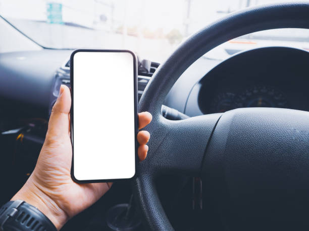 istock Blank empty screen smartphone on holder in car use for Navigation or GPS. Car interior view. 1332523214