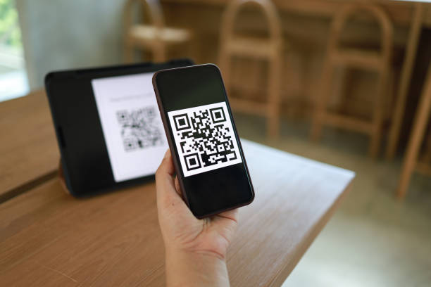 istock Qr code payment. Woman scanning QR code online shopping cashless technology concept. 1332523585