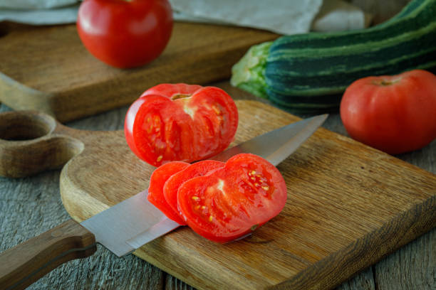 istock fresh tomatoes and knife on a chopping board 1332523586