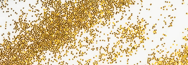 istock Festive or glamorous background. Gold sparkles scattered on a white background. 1332523672
