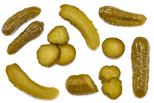 istock marinated pickled cucumbers with slices isolated on white background. Clipping path and full depth of field. Top view 1332525549