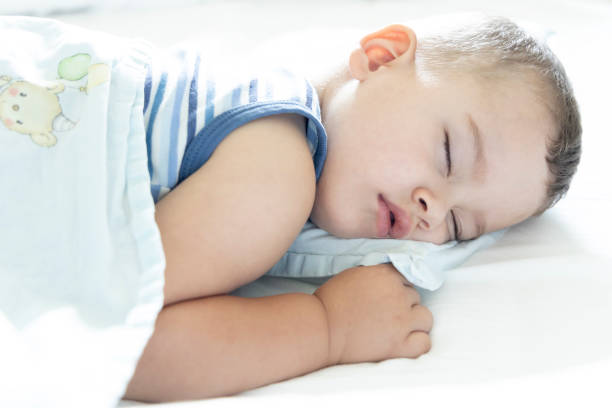 istock A cute little boy is sleeping in bed. 1332526003