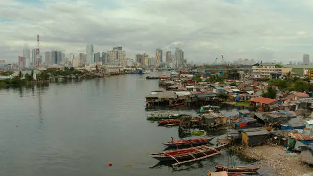 Manila is the capital of the Philippines with slums and poor district and skyscrapers and modern buildings.