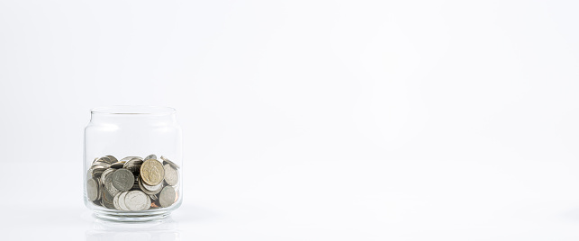 Glass jar with coins on a white background,Jar of Money Isolated on a White Background