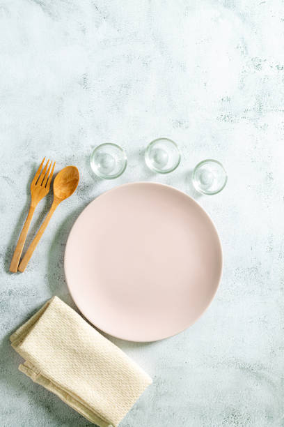 istock Empty white plate on gray concrete stone background. Top view, copy space 1332529501