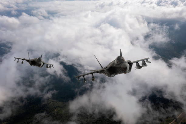 istock Jet fighters flying over the clouds. 1332530894