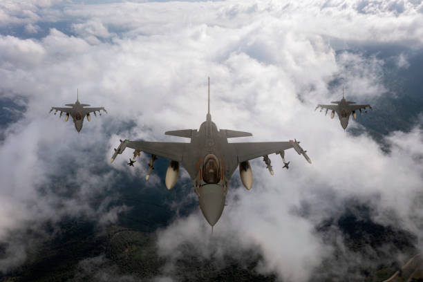 istock Jet fighters flying over the clouds. 1332530993