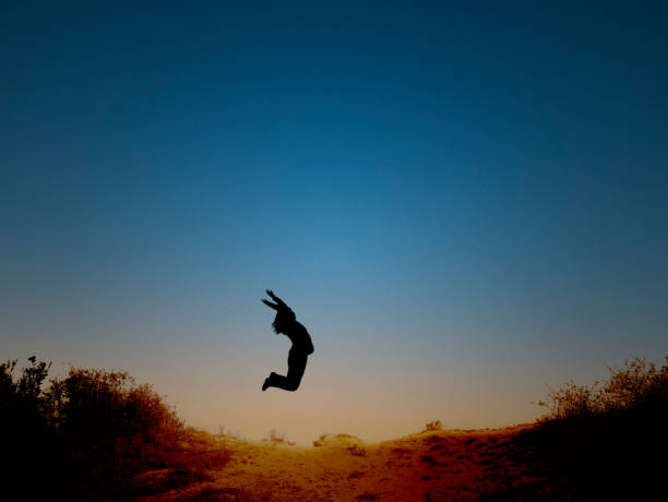istock Girl Jumping at the beach 1332533071