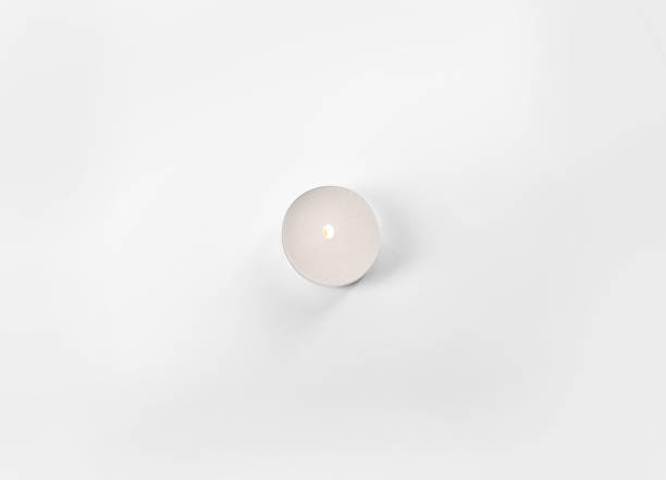 istock Burning tea candle isolated on white, top view 1332533363