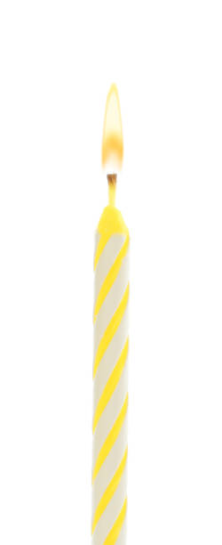 istock Yellow birthday cake candle isolated on white 1332533438
