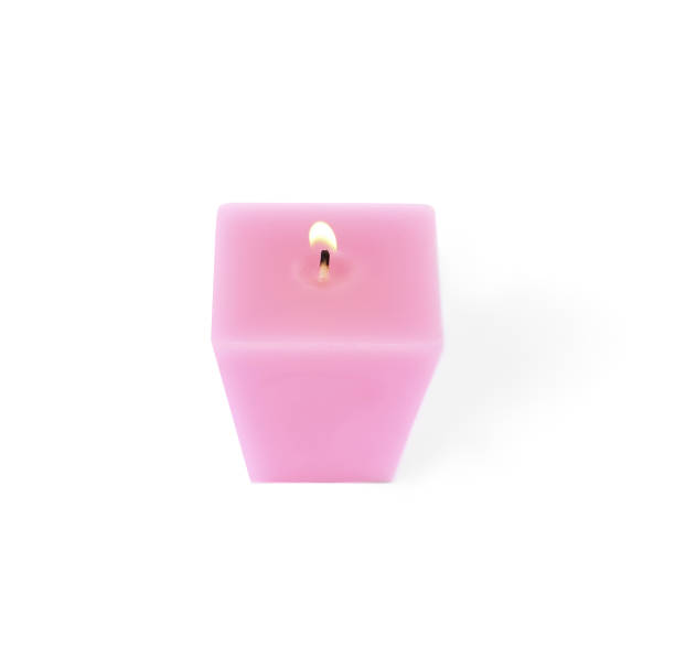 istock Small burning pink candle isolated on white 1332533544