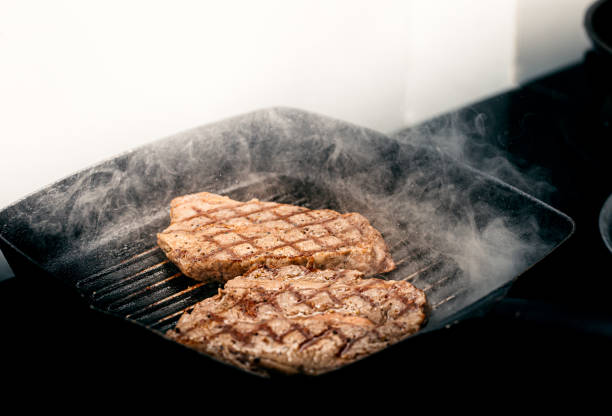istock Close up wagyu beef striploin steak with pepper on dark pan 1332535690