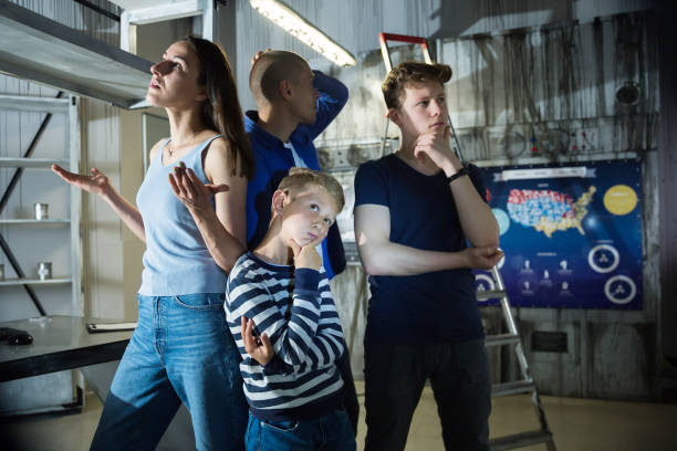 istock Brooding family tries to find a solution to a puzzle in a quest room 1332536524