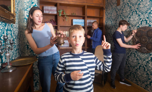 istock Smart preteen boy gesturing with forefinger in quest room 1332536617