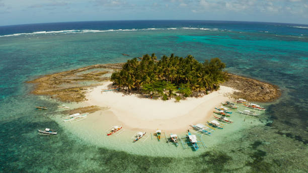 istock Tropical Guyam Island with a sandy beach and tourists 1332537451