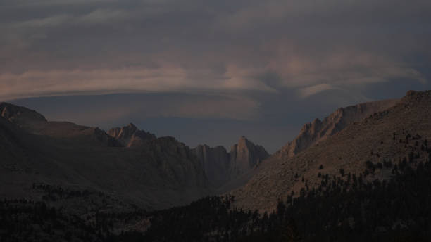 Sunset with dramatic clouds over Mount Whitney on the Pacific Crest Trail seen from Crabtree Meadows along the PCT California Section G from Walker Pass in the USA.