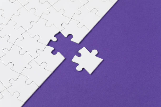 istock Jigsaw Puzzle on Purple Background 1332540585