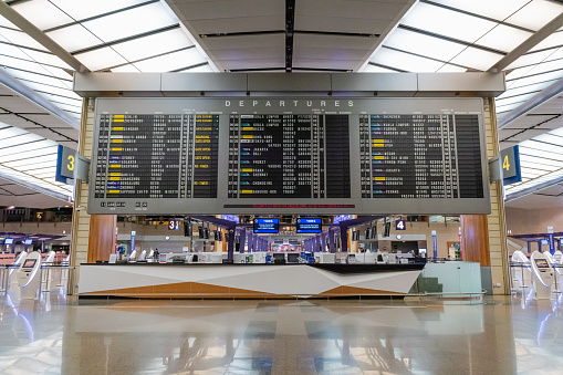 Singapore - January 2019: Singapore Changi Airport terminal with big departure schedule display. Changi Airport is one of the busiest airports in Asia