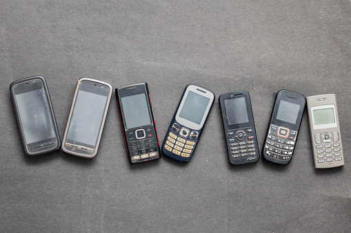 groups of old mobile phones with black background.