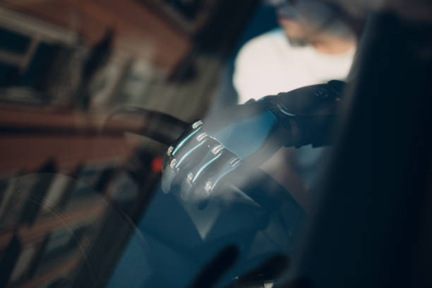 istock Young disabled man driver with artificial prosthetic hand driving vehicle car. 1332540996