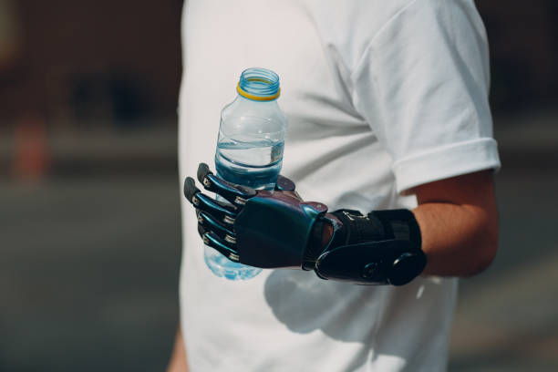 istock Young disabled man hold and drink bottled pure water with artificial prosthetic hand in casual clothes. 1332542000