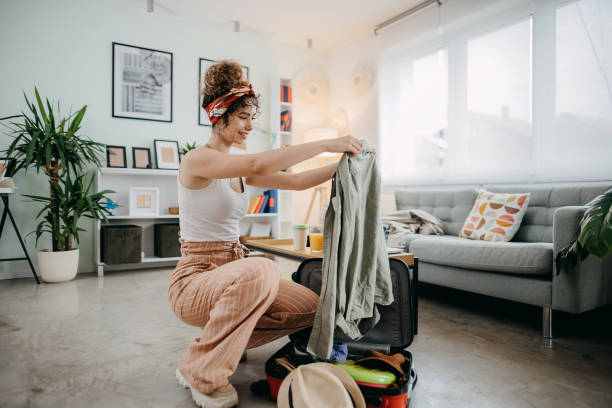 Always prepared Young woman preparing for road trip, packing suitcase packing stock pictures, royalty-free photos & images