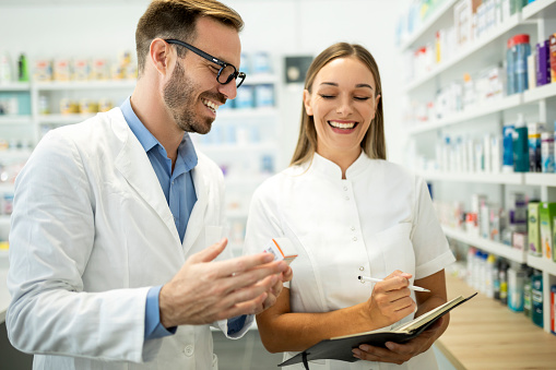 Pharmacists Working In The Pharmacy Store Together Stock Photo ...