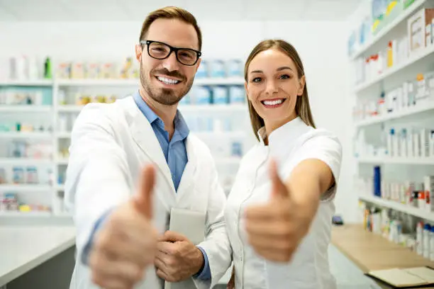 Pharmacy chemist team women and man in drugstore