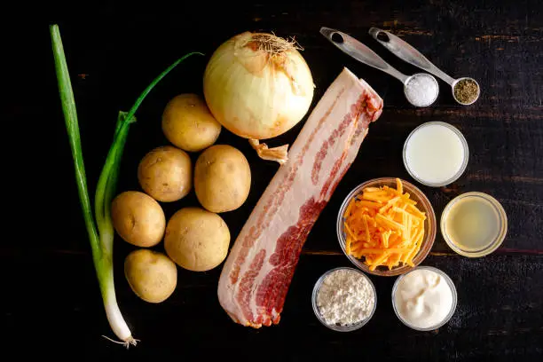 Raw potatoes, shredded cheese, bacon, sour cream, and other ingredients