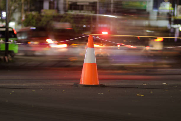 istock Traffic cone with light trails and blurred background to illustrate Lockdown for Covid-19 Pandemic prevention in Sukabumi city, West Java, Indonesia. 1332549660