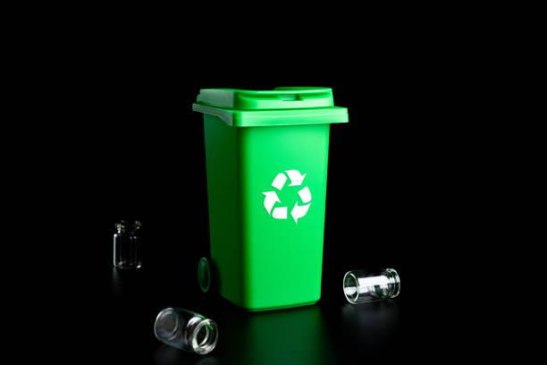 istock Trash glass sort. Bin container for disposal garbage waste and save environment. Green dustbin for recycle glass can trash isolated on black background. 1332550796