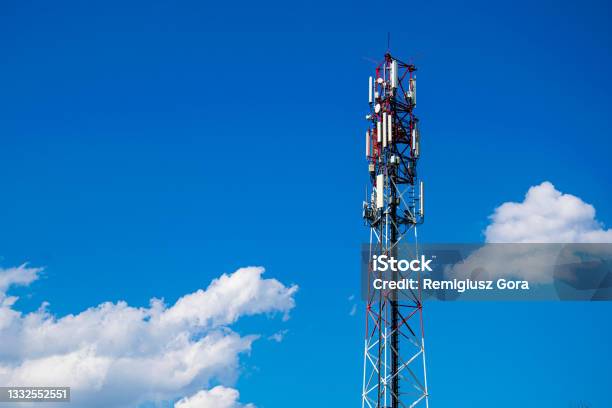 Telecommunication Tower Of 4g And 5g Cellular Macro Base Station 5g Radio Network Telecommunication Equipment With Radio Modules And Smart Antennas Mounted On A Metal Against Cloulds Sky Background Stock Photo - Download Image Now