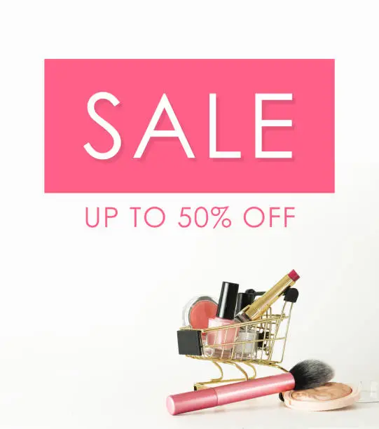 Photo of Sale banner. Shopping trolley full of make up and cosmetic goods on white background. Black friday concept. Sale and discount. Goods for women. Closeup of a basket with products for make-up.