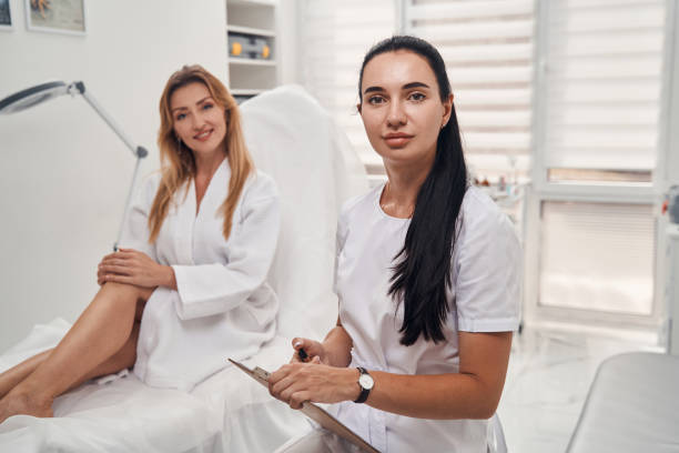 istock Cheerful female cosmetologist with client in office 1332555071