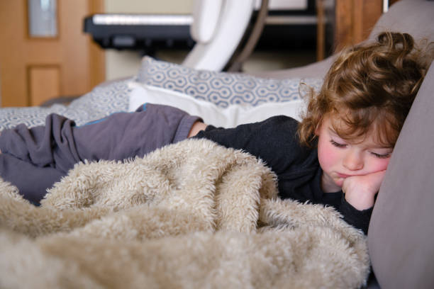 istock Sleepy toddler child napping in the afternoon on a sofa 1332555344