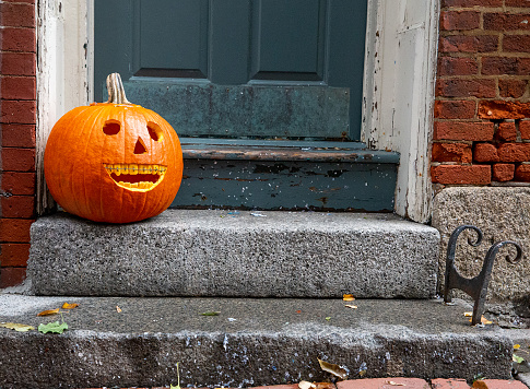 funny Halloween pumpkin on the doorstep. Orthodontic or dentist office. copy space for your text