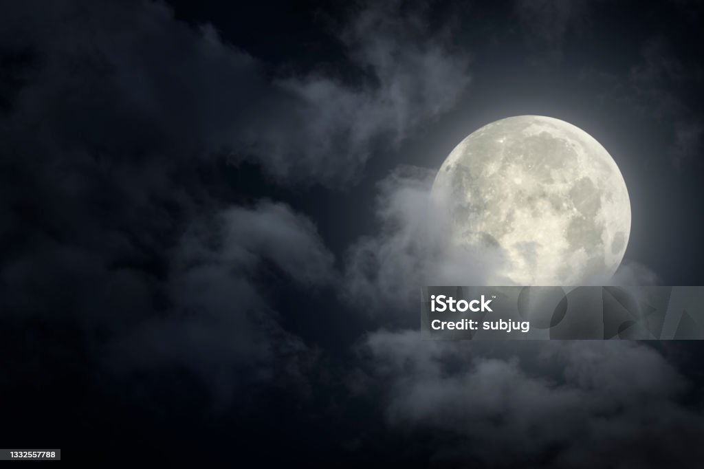 Dramatic sky with full moon Dramatic sky with full moon behind clouds Moon Stock Photo
