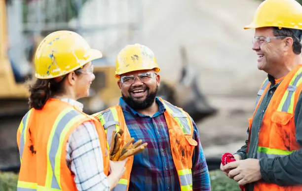 Photo of Three multi-ethnic construction workers chatting