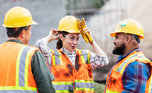 istock Hispanic woman and two men, workers at construction site 1332558298