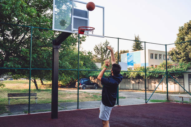 istock Teenage boy playing basketball. Copy space. 1332559340