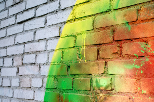 istock Art texture: a brick wall is painted with multi-colored spray paints. 1332560630