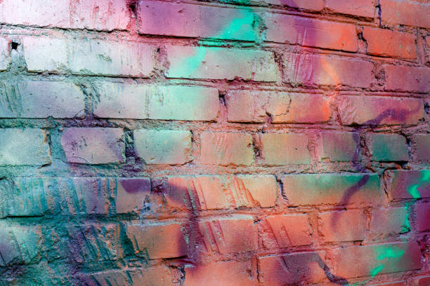 istock Art texture: a brick wall is painted with multi-colored spray paints. 1332561651